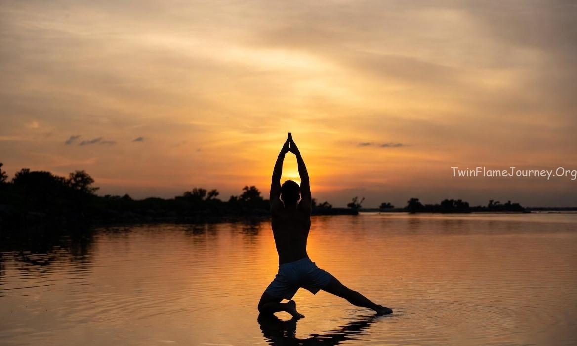 The golden light reflects off the water, symbolizing the awakening of the Divine Masculine energy