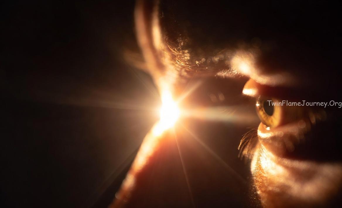 A glowing light (representing Atman) illuminating an eye, with shadows representing 'Maya' fading away